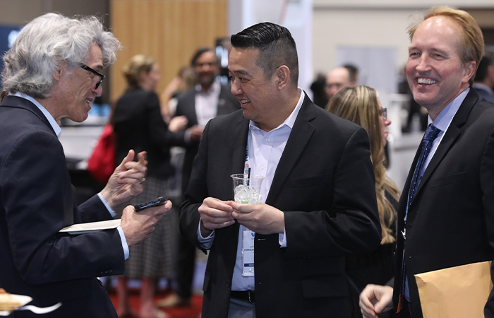 Three men laughing at a function