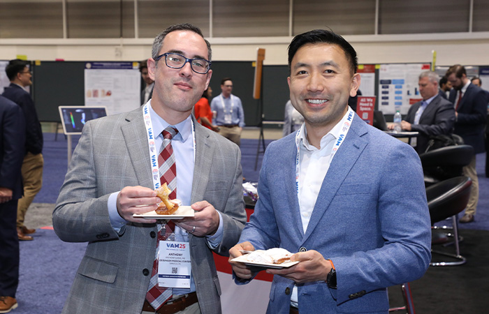 Two people posing with food smiling at camera